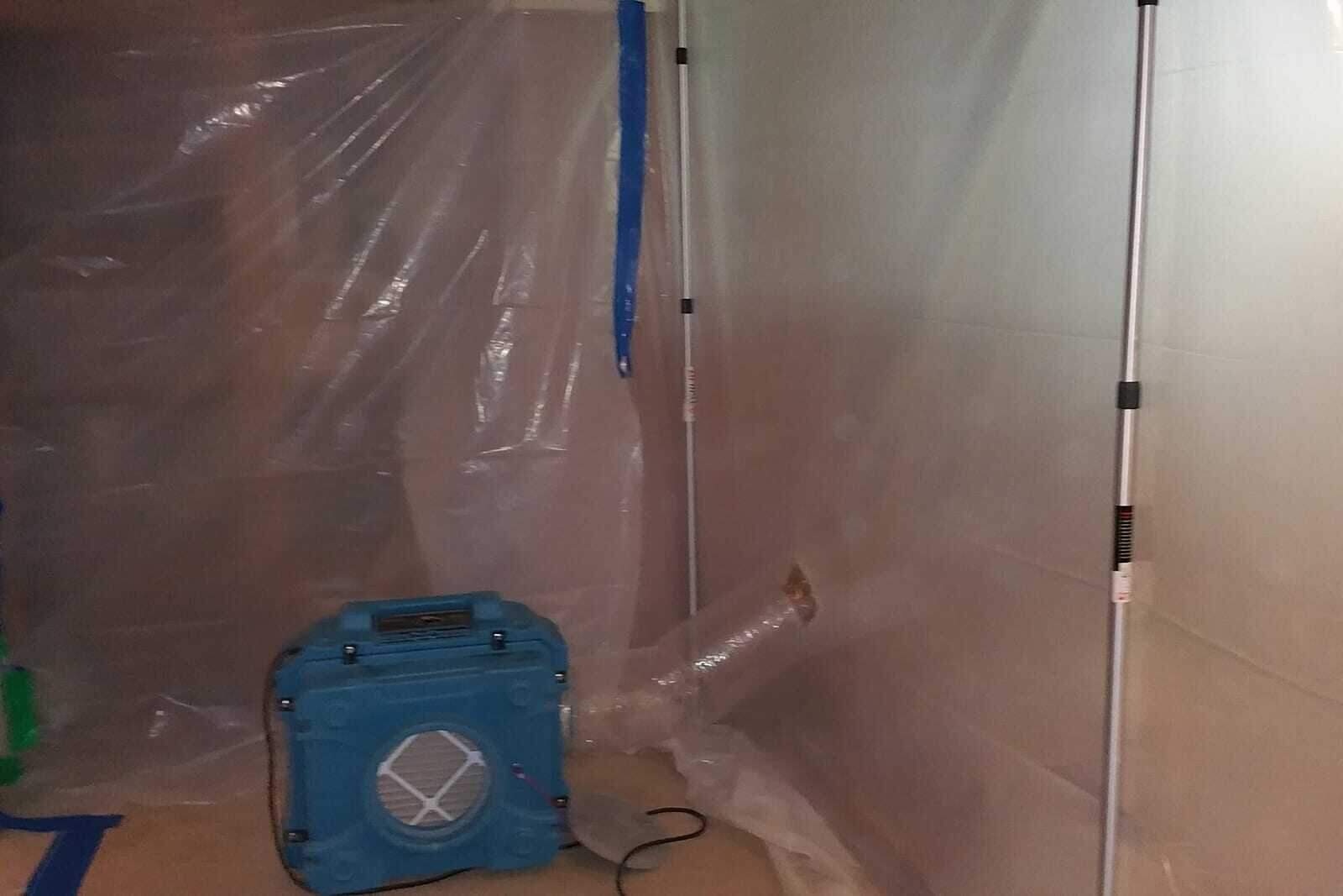 Mold containment with plastic barriers and a HEPA air scrubber in a Houston home